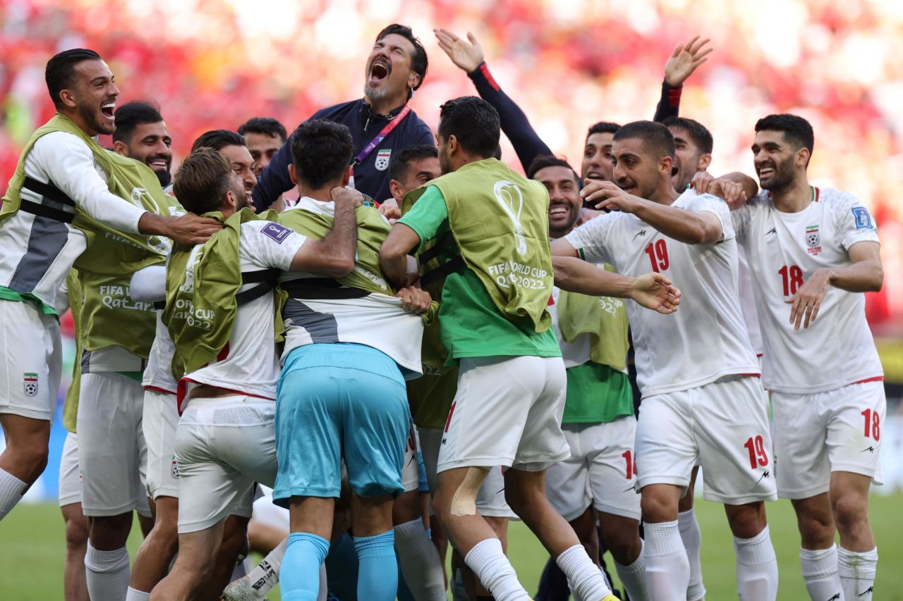 Iranian players celebrate after Roozbeh Cheshmi scored late into second-half stoppage time to break a 0-0 deadlock against Wales on Friday. Iran added another goal to win 2-0.