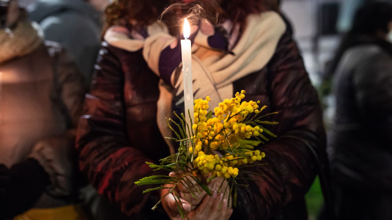 A woman holds a candle during the torchlight procession against Anna Borsa's femicide on March 1, 2022 in Pontecagnano Faiano, Italy. 