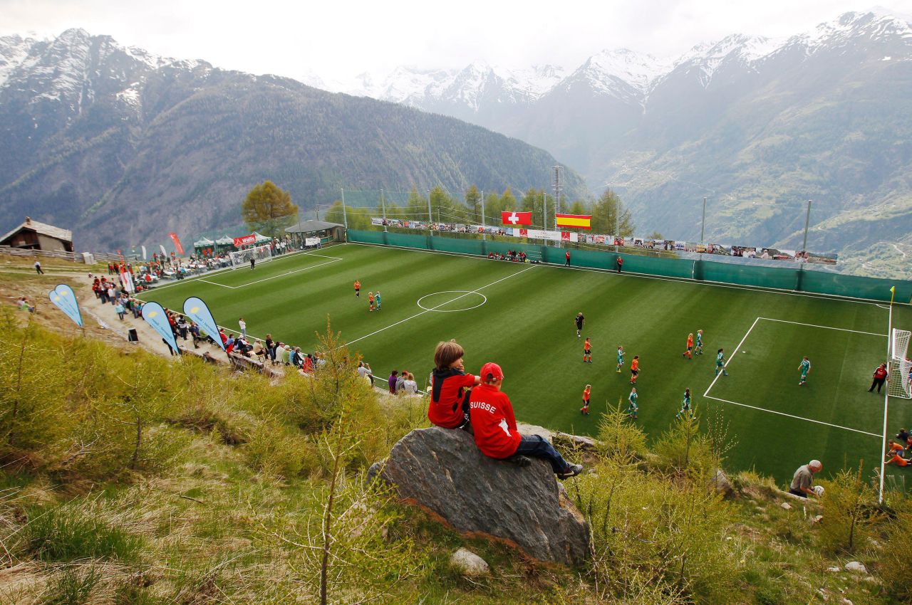 Boys watch a Mountain Villages women's friendly soccer match between FC Gspon and FC Saas in Gspon, in the Swiss Alps. At some 2000 meters, the pitch can only be reached by cable car lift that can carry up to 10 people or after a 45 minutes walk.