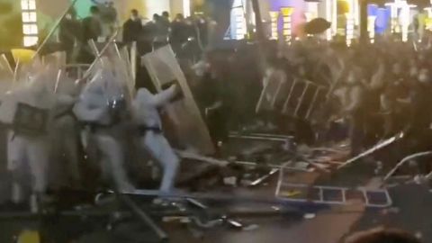 Security forces clash with workers during a protest outside Apple supplier Foxconn's factory in Zhengzhou, China, on November 23.