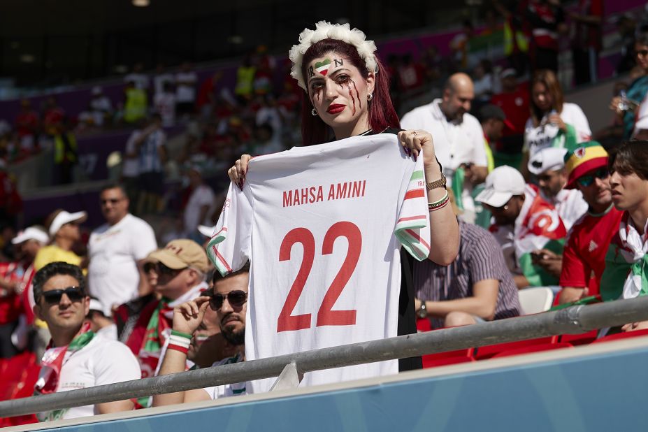 A fan holds a Mahsa Amini jersey as a <a href="https://www.cnn.com/sport/live-news/world-cup-11-25-2022/h_13ff0249156256f8afb9d32bd699c870" target="_blank">protest before the Iran-Wales match</a>. Recent protests in Iran were sparked by the death of Amini, a 22-year-old woman who died after being detained by Iran's morality police allegedly for not abiding by the country's conservative dress code.