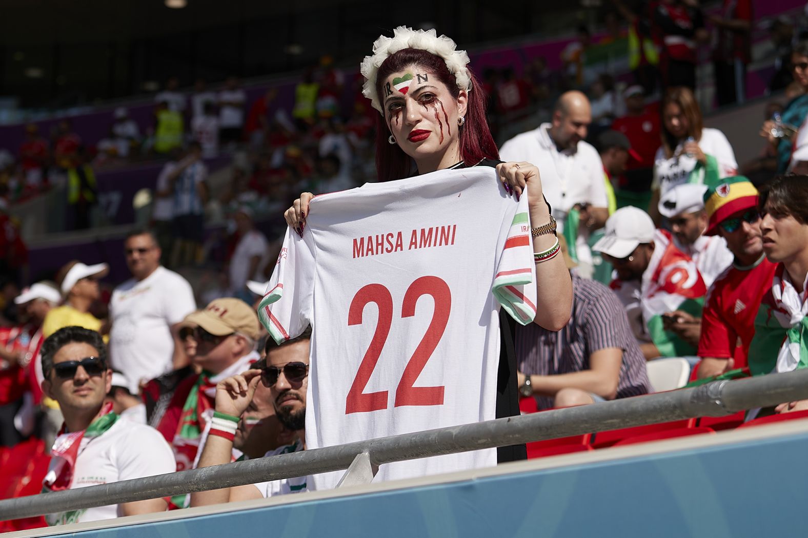 A fan holds a Mahsa Amini jersey as a <a href="index.php?page=&url=https%3A%2F%2Fwww.cnn.com%2Fsport%2Flive-news%2Fworld-cup-11-25-2022%2Fh_13ff0249156256f8afb9d32bd699c870" target="_blank">protest before the Iran-Wales match</a>. Recent protests in Iran were sparked by the death of Amini, a 22-year-old woman who died after being detained by Iran's morality police allegedly for not abiding by the country's conservative dress code.