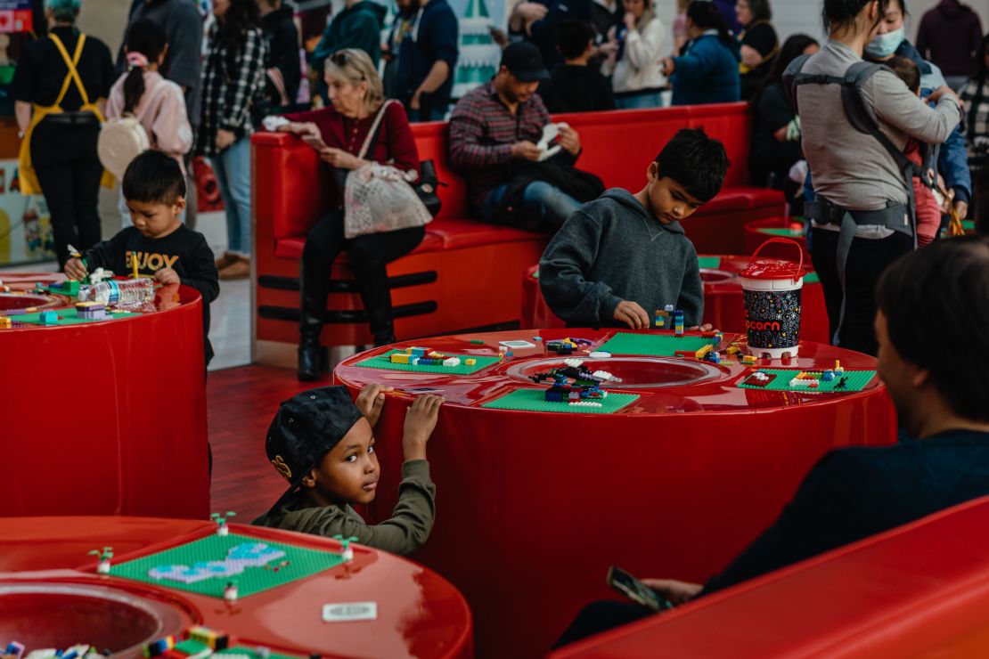 Children play at the mall's Lego store.