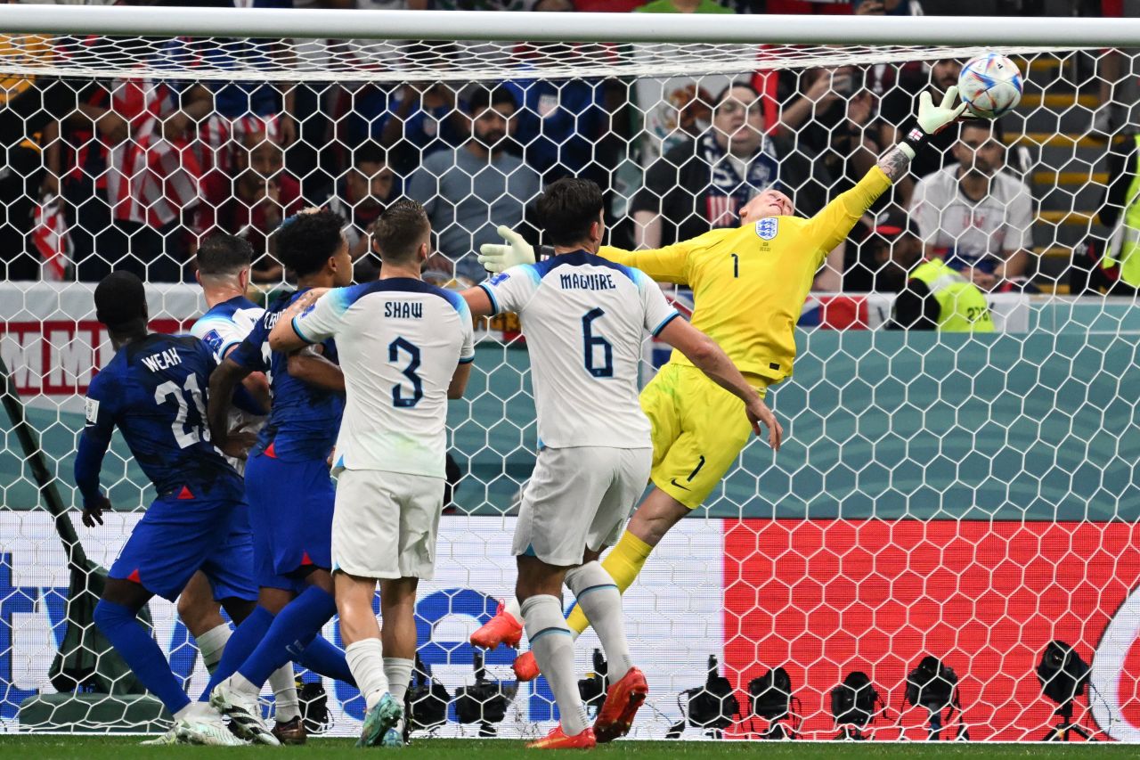 England goalkeeper Jordan Pickford dives to make a save in the match against the United States.