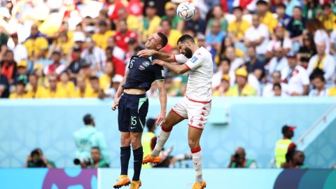 Mitch Duke competes for the ball with Tunisia's Yassine Meriah.