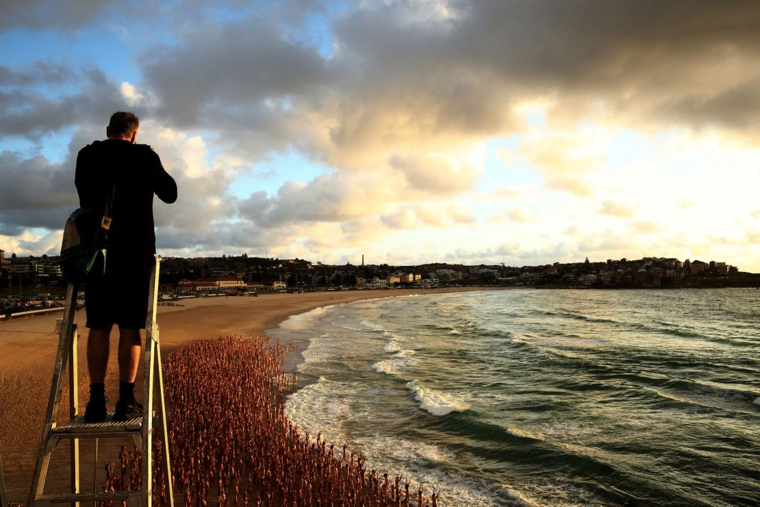 Spencer Tunick pictured photographing participants on Bondi Beach.