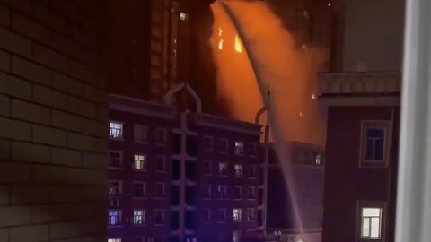 Firefighters spray water on a fire at a residential building in Urumqi in western China's Xinjiang region on Nov. 24, 2022.