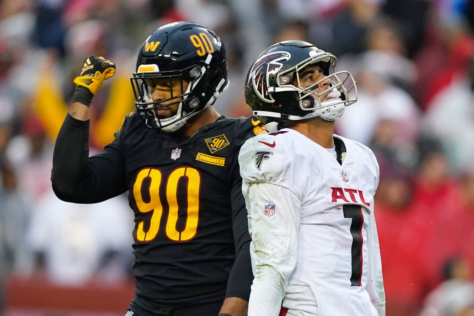 Two sides of the coin... Atlanta Falcons quarterback Marcus Mariota and Washington Commanders defensive end Montez Sweat react to Mariota's second half interception on November 27. Washington won the game 19-13.