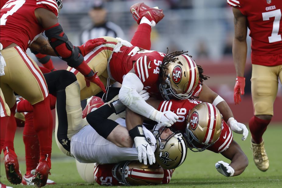 New Orleans Saints tight end Taysom Hill is tackled by San Francisco 49ers defensive end Samson Ebukam, linebacker Fred Warner and defensive tackle Kevin Givens in the second half on November 27. The 49ers would go on to shut out the Saints 13-0 to move to 7-4 on the year.