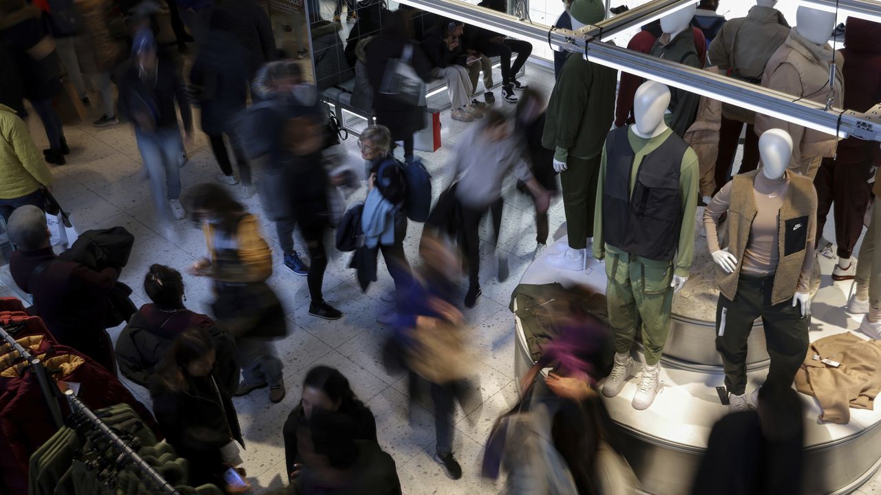 People shop in a Nike store on Black Friday, Nov. 25, 2022, in New York. 