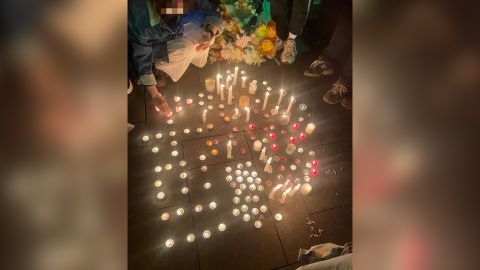 Protesters in Chengdu hold candles to commemorate the victims of the fire in Xinjiang on November 27.