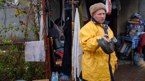 Valeriy shows a piece of the Russian shell that landed in his yard.