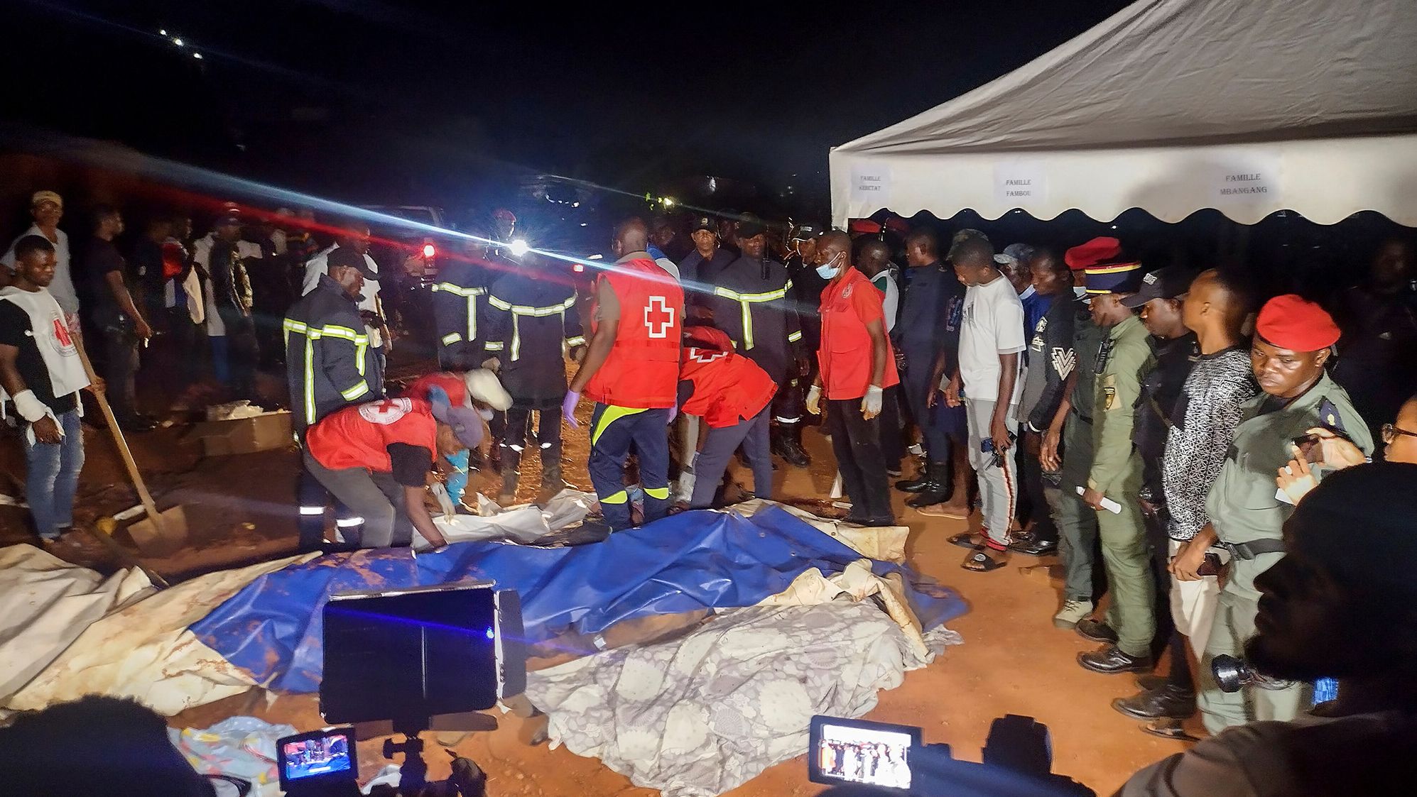 Rescuers prepare to carry a body after a landslide, which killed people who were attending a funeral, the governor of Cameroon's Centre Region said, in Yaounde, Cameroon November 27, 2022.
