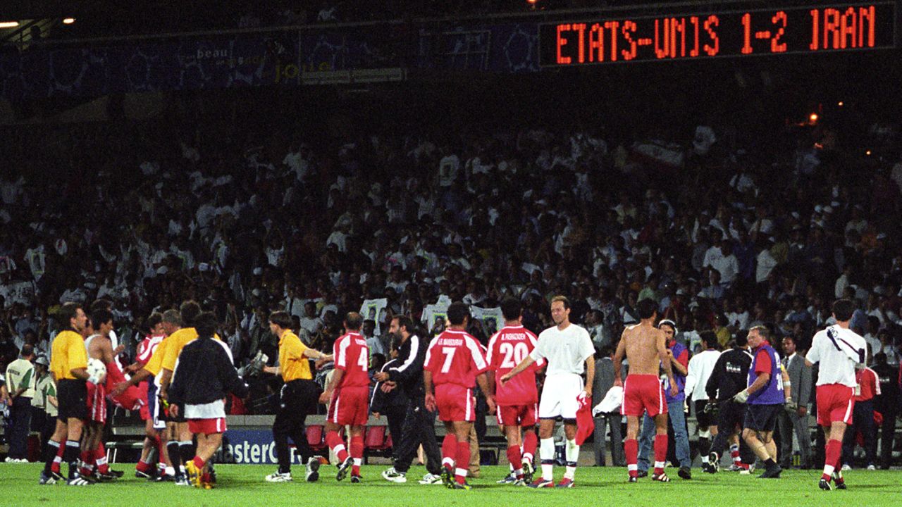 The two teams shake hands after the final whistle.