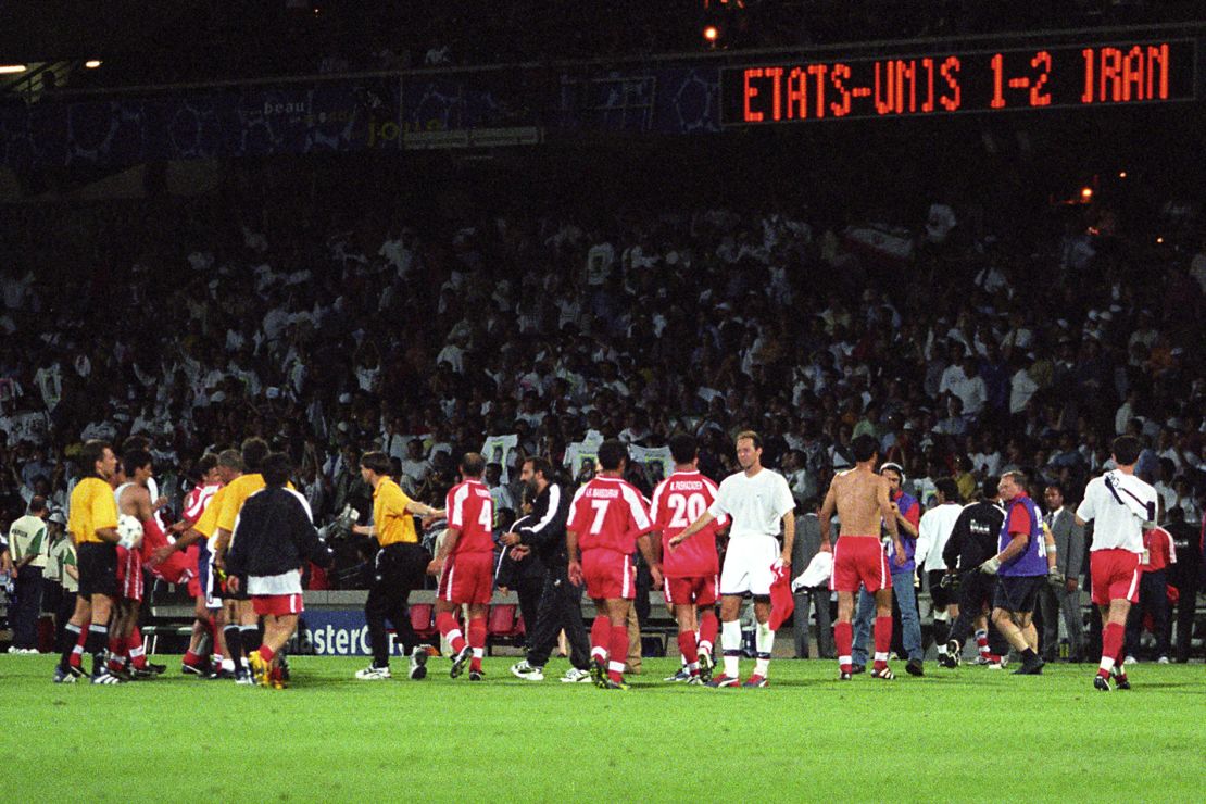 The two teams shake hands after the final whistle.