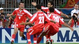 Iranian midfielder Hamid Estili (L) jubilates with teammates Mehrdad Minavand (21) and Mehdi Pashazadeh after scoring 21 June at the Gerland stadium in Lyon, central France, during the 1998 Soccer World Cup Group F first round second match between Iran and the United States.  (ELECTRONIC IMAGE) AFP PHOTO  PATRICK KOVARIK (Photo by PATRICK KOVARIK / AFP)        (Photo credit should read PATRICK KOVARIK/AFP via Getty Images)