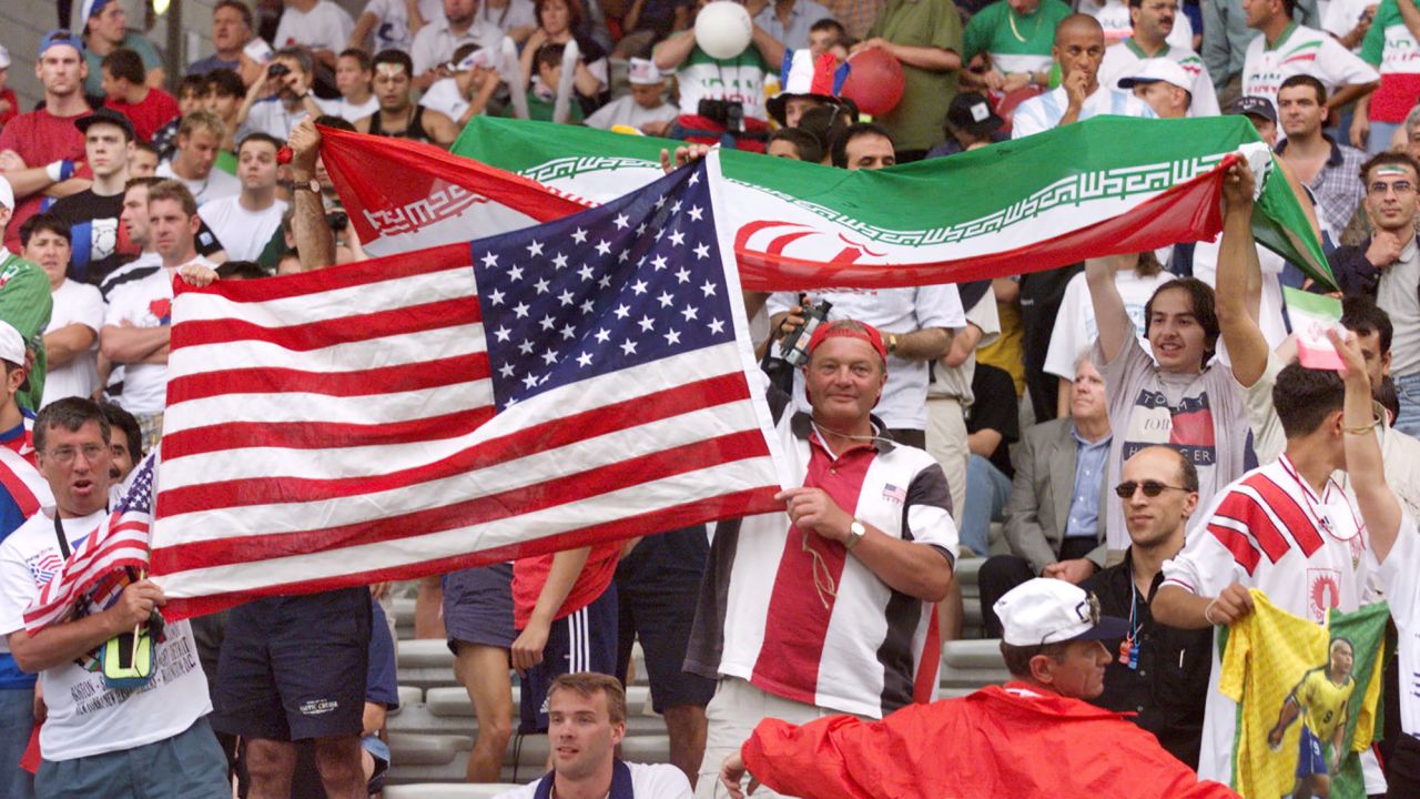 Iranian and US fans wave their national flags before kickoff.