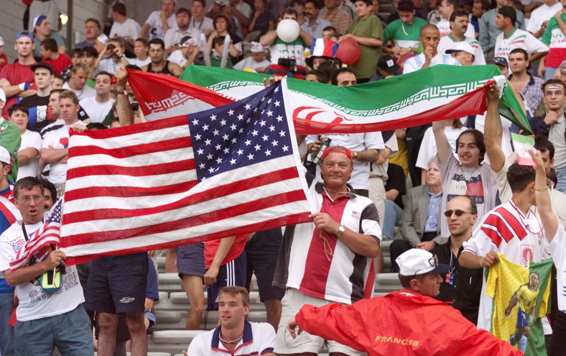 Iranian and US fans wave their national flags before kickoff. 