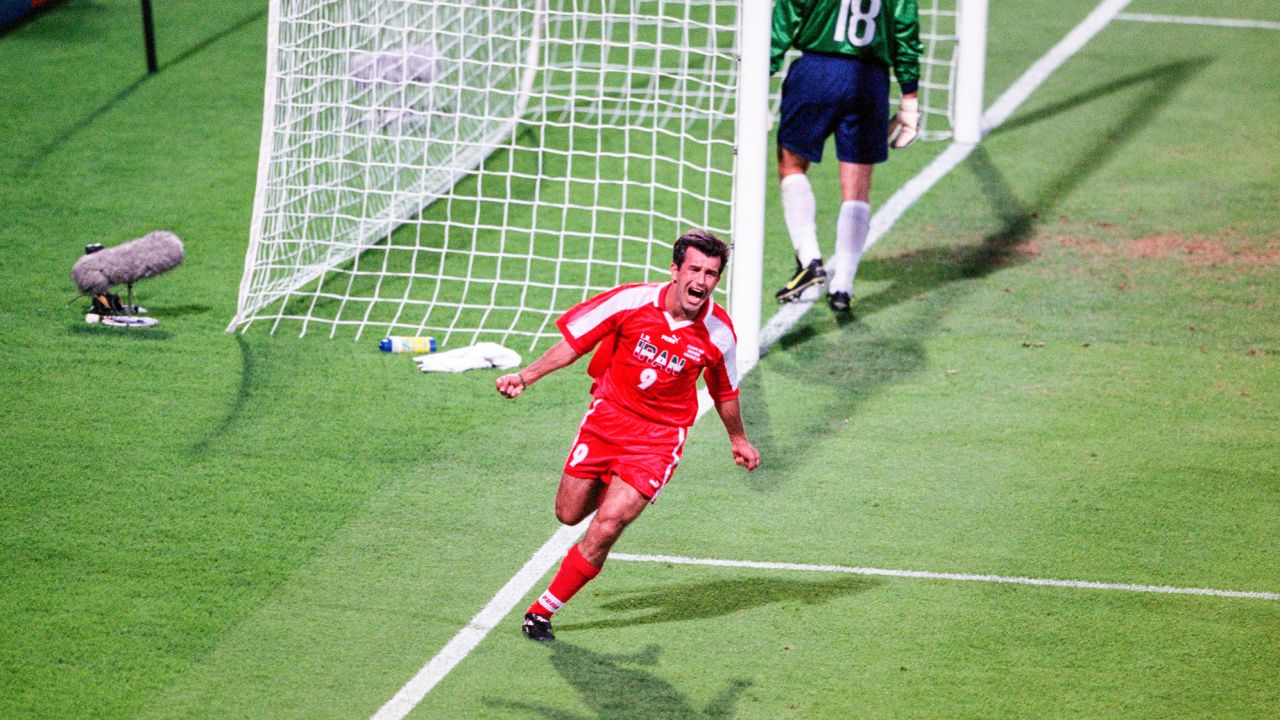 Hamid Estili celebrates scoring Iran's first goal.
