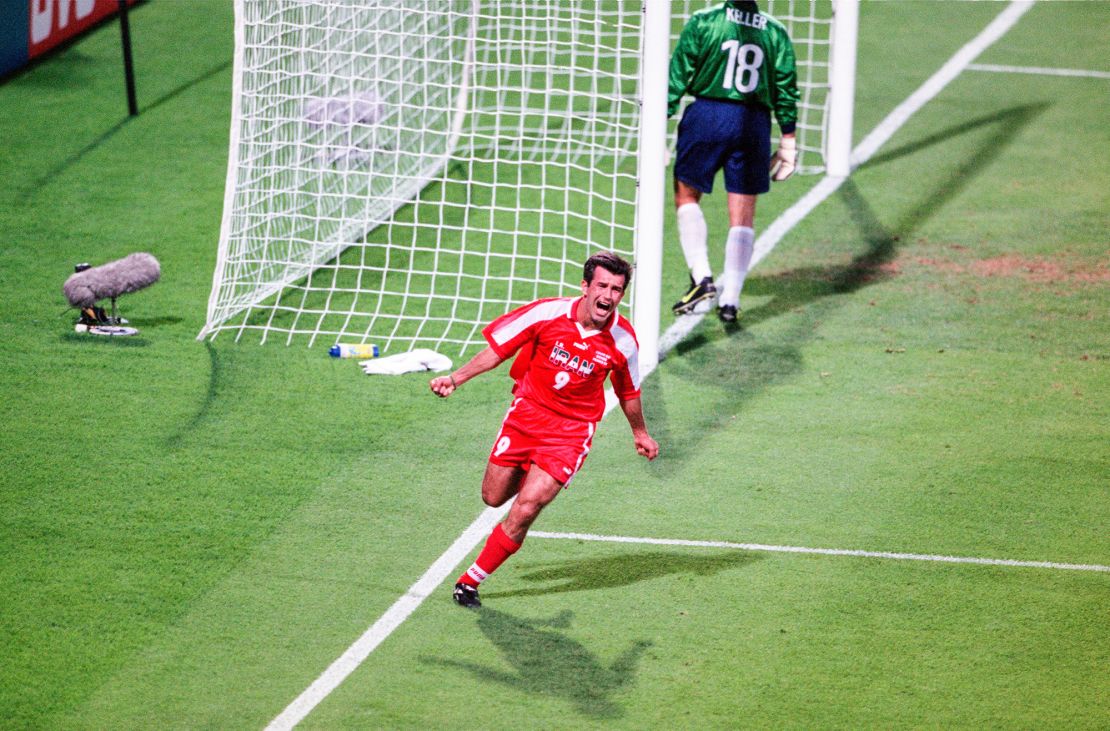 Hamid Estili celebrates scoring Iran's first goal.