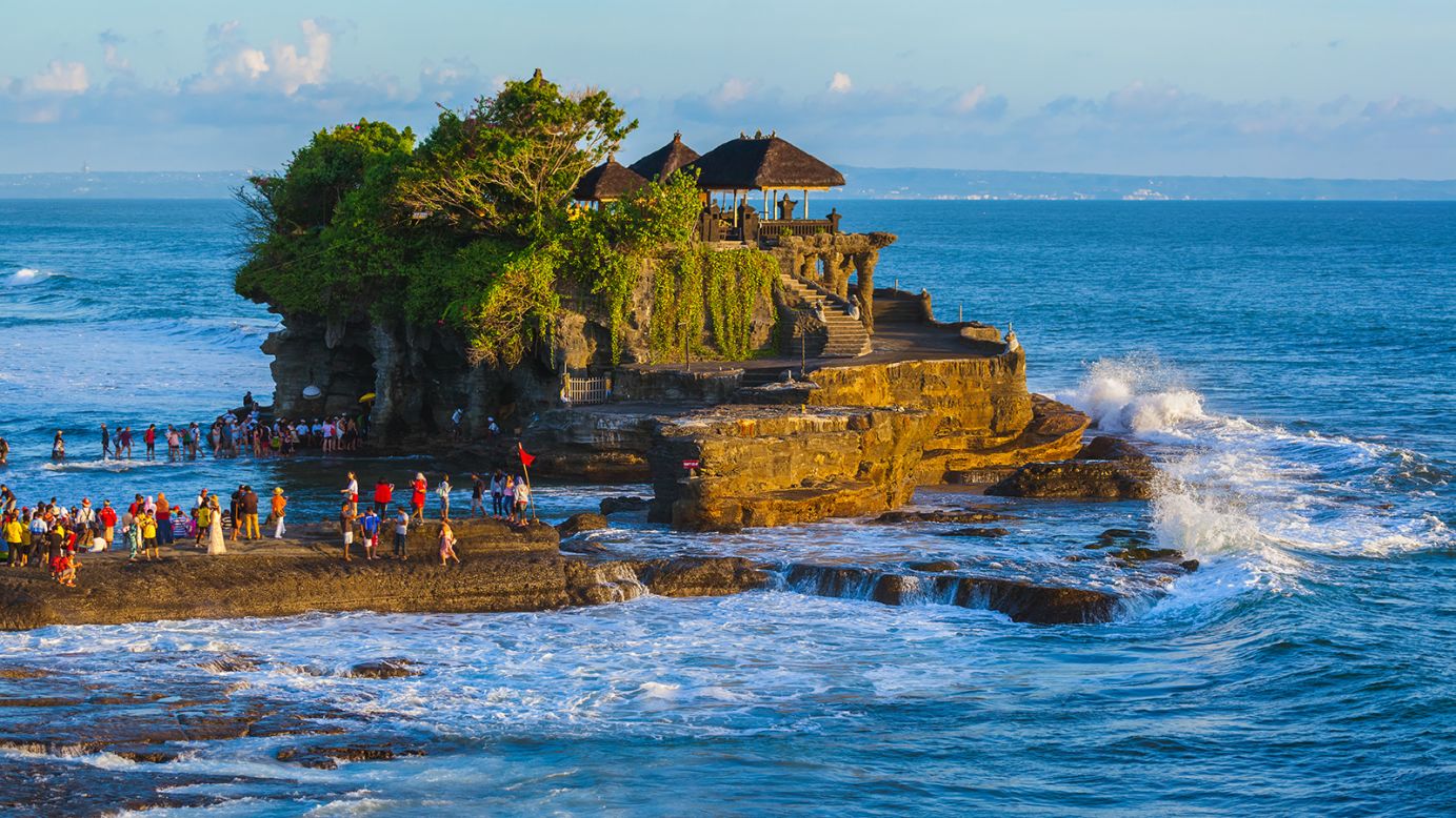 <strong>Tanah Lot:</strong> One of Bali's most photographed places, Tanah Lot is a rock formation that sites about 300 meters from the shore. It's home to the ancient Pura Tanah Lot temple. 