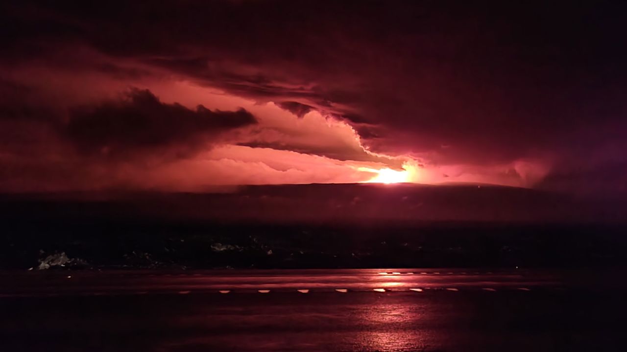 Red hues from the eruption of Mauna Loa illuminated Monday's predawn sky.