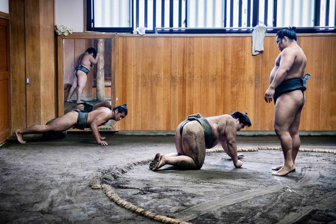 A wrestler on the floor during a punishing form of collision training known as 'butsukari-geiko'