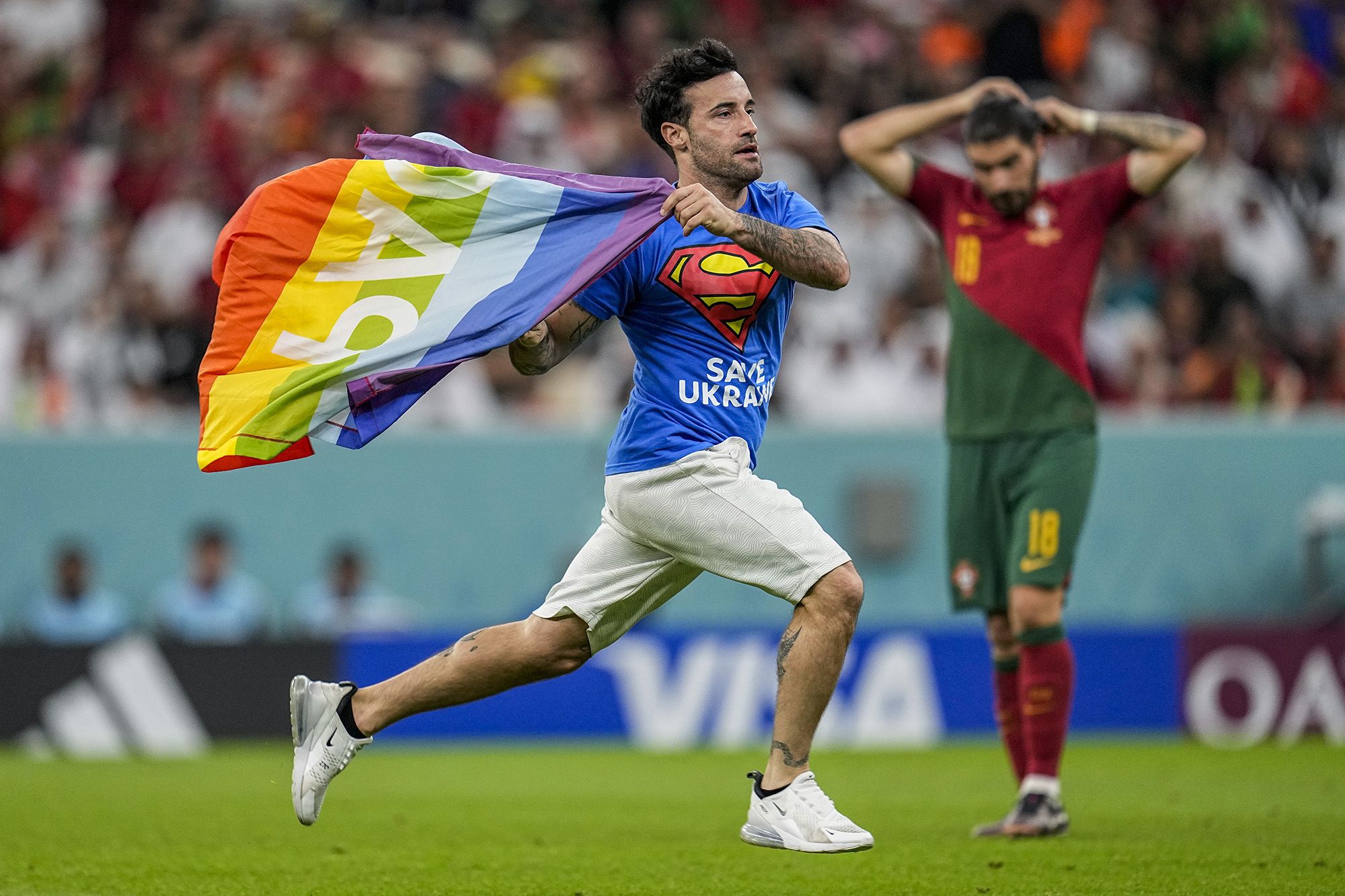 Portugal vs. Uruguay: Pitch invader with rainbow flag interrupts