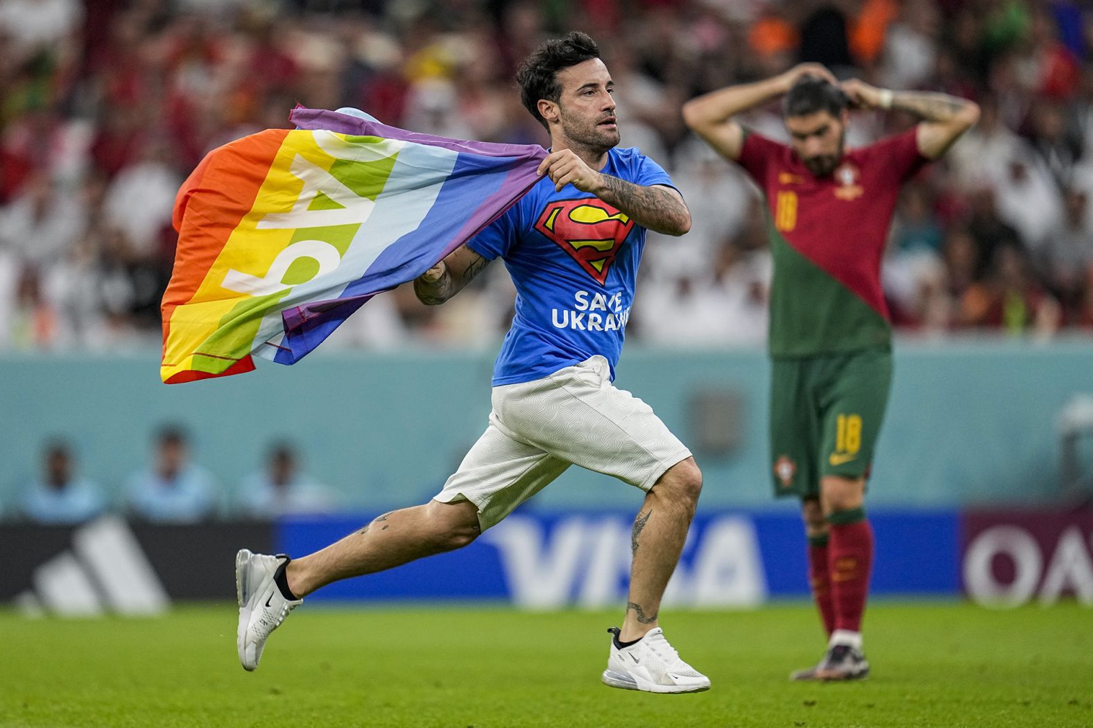 A man <a href="index.php?page=&url=https%3A%2F%2Fwww.cnn.com%2F2022%2F11%2F28%2Ffootball%2Fpitch-invader-rainbow-flag-2022-world-cup-spt-intl%2Findex.html" target="_blank">runs onto the field with a rainbow flag</a> during the match between Portugal and Uruguay. The man, an Italian named Mario Ferri, was also wearing a shirt that said "save Ukraine" on the front and "respect for Iranian women" on the back. In a series of posts of his Instagram story, Ferri called himself the "new Robin Hood" and said, "Breaking the rules if you do it for a good cause is NEVER A CRIME." He was banned from attending future matches.