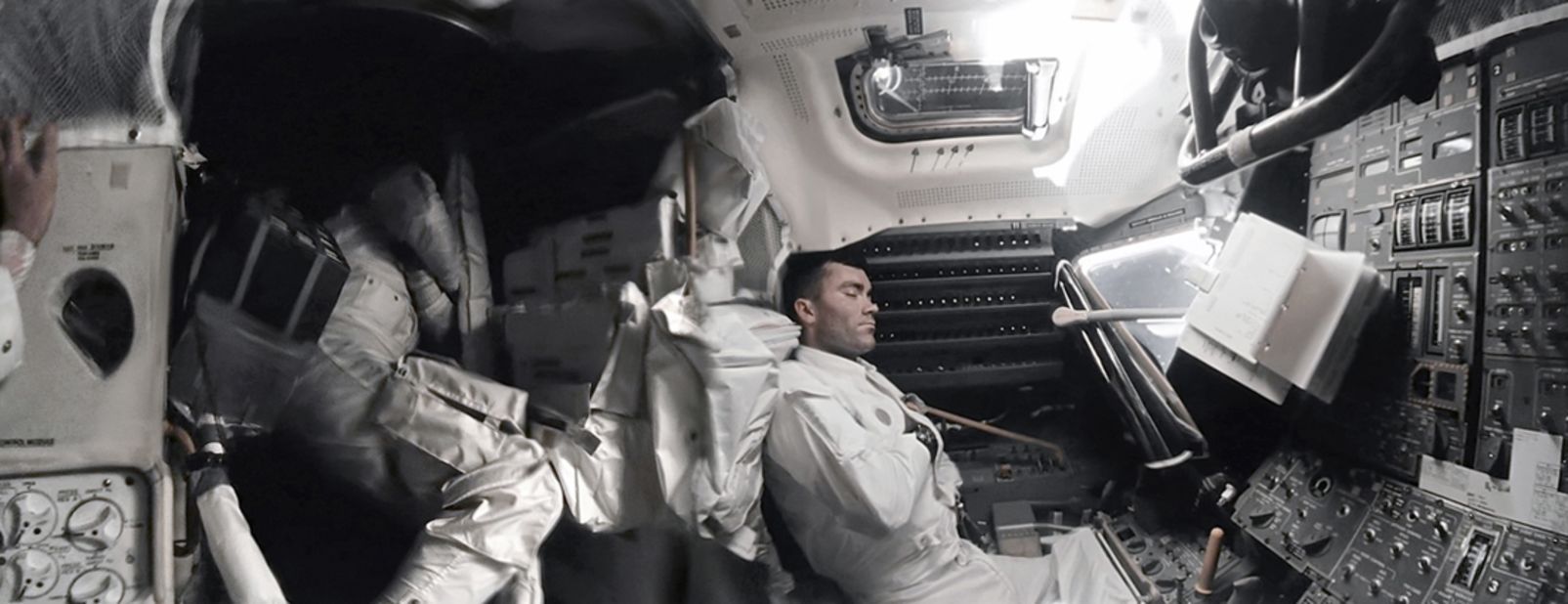 Astronaut Fred Hause (right) takes a nap inside the Apollo 13 Lunar Module, nicknamed "lifeboat" after the crew was forced to shelter in it, following the failure of an oxygen tank in the service module.