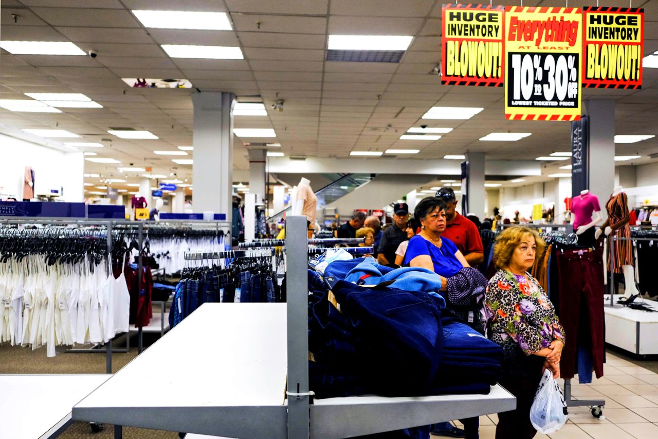 Shoppers wait in line by an empty rack of jeans during a 2019 Black Friday sale at a Sears store in Hialeah, Florida.