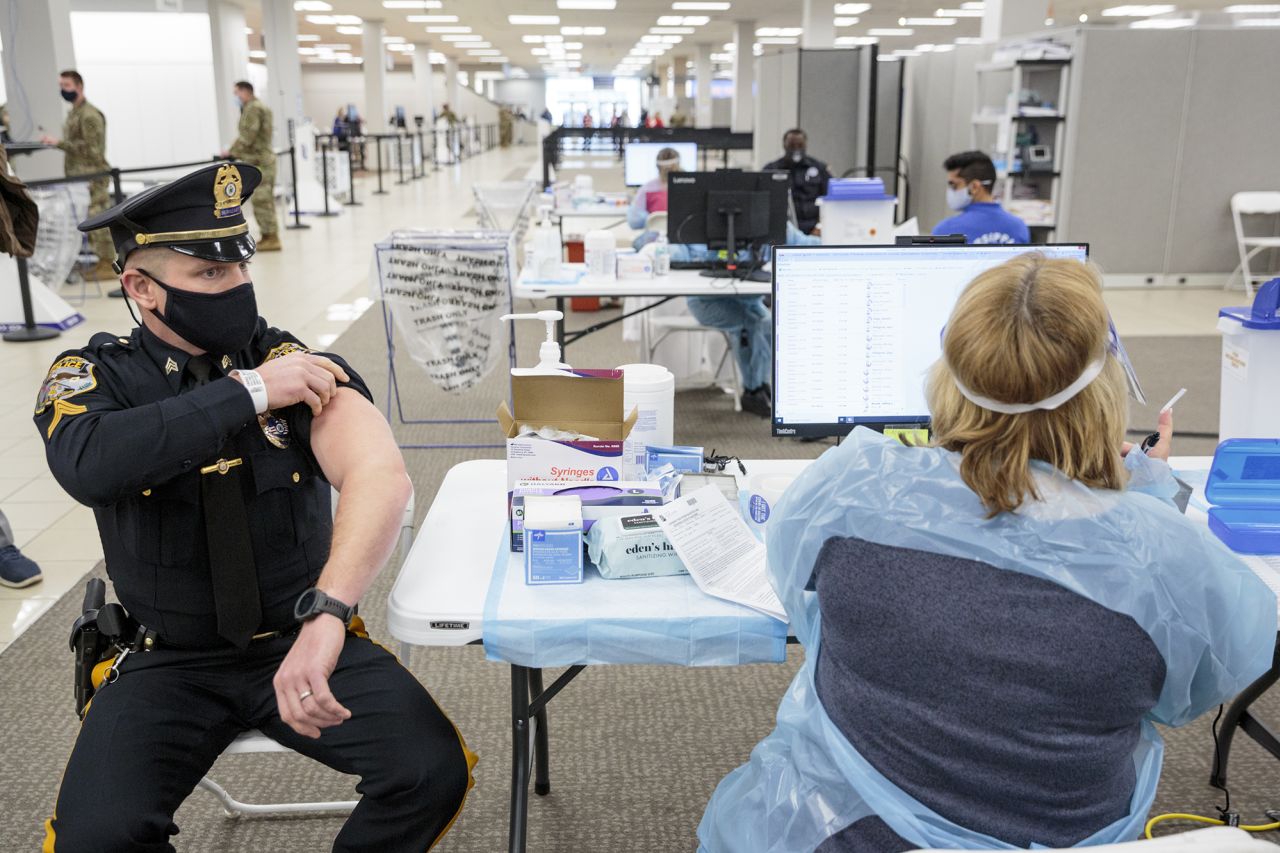 A police sergeant receives a Covid-19 vaccination in a former Sears store at the Townsquare Mall in Rockaway, New Jersey, in 2021.