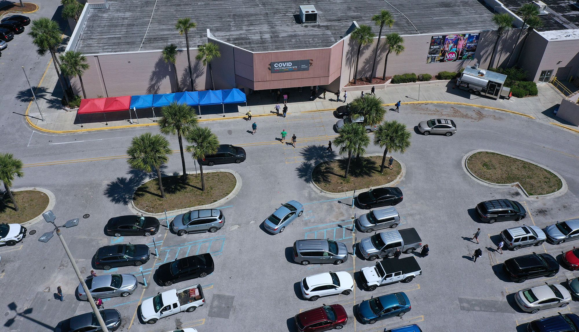 People arrive to receive Covid-19 shots in 2021 at a vaccination site in a former Sears store at the Lake Square Mall in Leesburg, Florida.