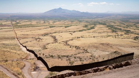 The US-Mexico border fence sprawls back into space in Cochise County south of Sierra Vista, Arizona, June 13, 2022. 