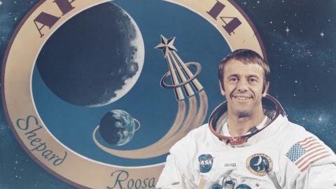 1970 年，謝潑德在阿波羅 14 號任務徽章前擺姿勢。