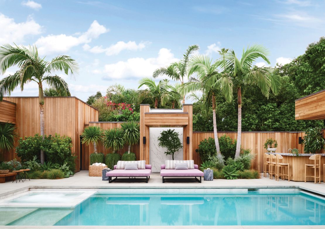 The property's inner courtyard juxtaposes clean lines and crisp marble with lush greenery and pops of color on poolside furnishings.