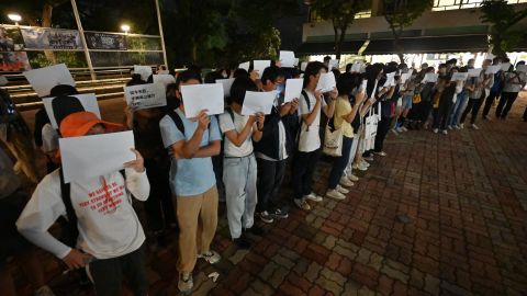 Students hold up placards, including blank white sheets of paper, on the campus of the Chinese University of Hong Kong on November 28, 2022, in solidarity with protests held on the mainland over Beijing's Covid-19 restrictions.