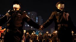 Police officers stand guard as people protest coronavirus disease (COVID-19) restrictions and hold a vigil to commemorate the victims of a fire in Urumqi, as outbreaks of the coronavirus disease continue, in Beijing, China, November 27, 2022. REUTERS/Thomas Peter 