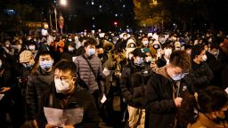 Protesters march along a street during a rally for the victims of a deadly fire as well as a protest against China's harsh Covid-19 restrictions in Beijing on November 28, 2022. - A deadly fire on November 24, 2022 in Urumqi, the capital of northwest China's Xinjiang region, has become a fresh catalyst for public anger, with many blaming Covid lockdowns for hampering rescue efforts, as hundreds of people took to the streets in China's major cities on November 27, 2022 to protest against the country's zero-Covid policy in a rare outpouring of public anger against the state. Authorities deny the claims. (Photo by Noel CELIS / AFP) (Photo by NOEL CELIS/AFP via Getty Images)