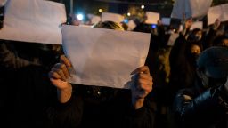 Protesters hold up a white piece of paper against censorship as they march during a protest against Chinas strict zero COVID measures on November 27, 2022 in Beijing, China.