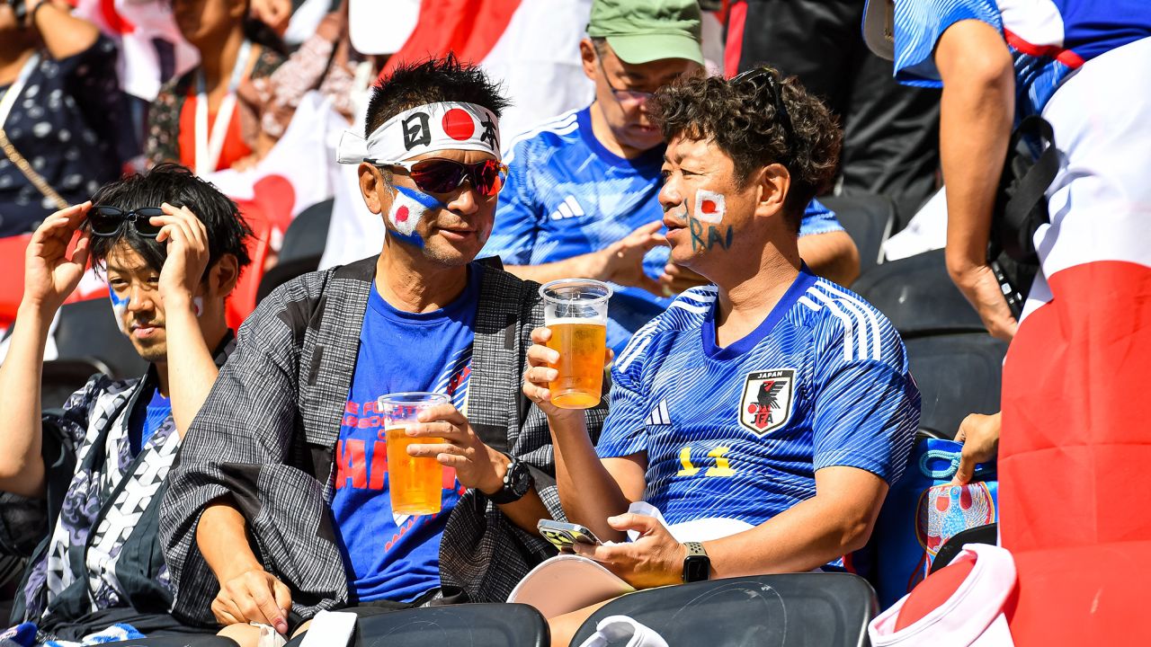 Fans of Japan drink alcohol free beer during a match at Qatar 2022. 