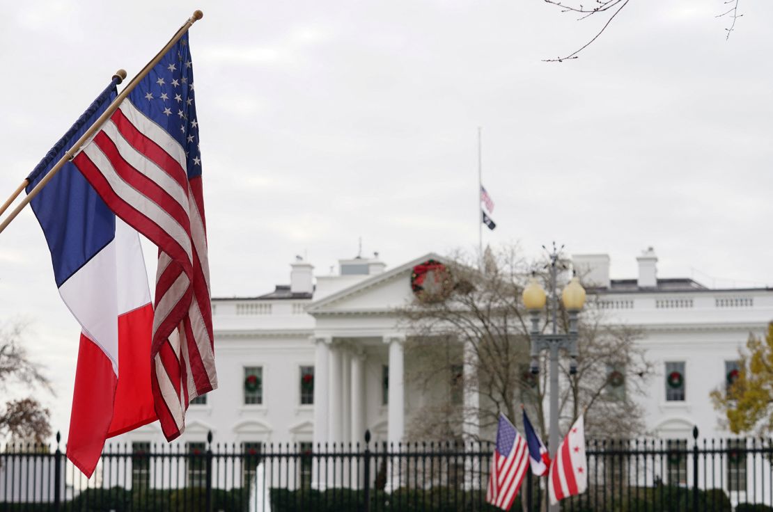 A French flag flies alongside the US flag in front of the White House in preparation for this week's state visit by French President Emmanuel Macron, in Washington, U.S., November 29, 2022. 