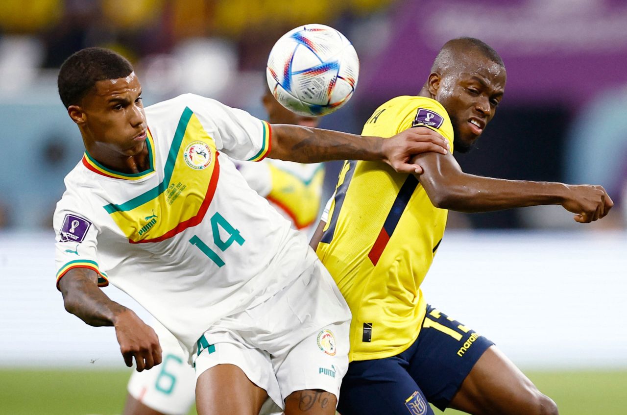 Senegal's Ismail Jakobs, left, tries to fend off Ecuador's Enner Valencia on November 29.