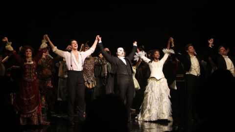 John Riddle as "Raoul", Ben Crawford as "The Phantom" and Emilie Kouatchou as "Christine" take the curtain call at The 34th Anniversary Performance of Andrew Lloyd Webber's "Phantom of The Opera" on Broadway at The Majestic Theater on January 26, 2022 in New York City.