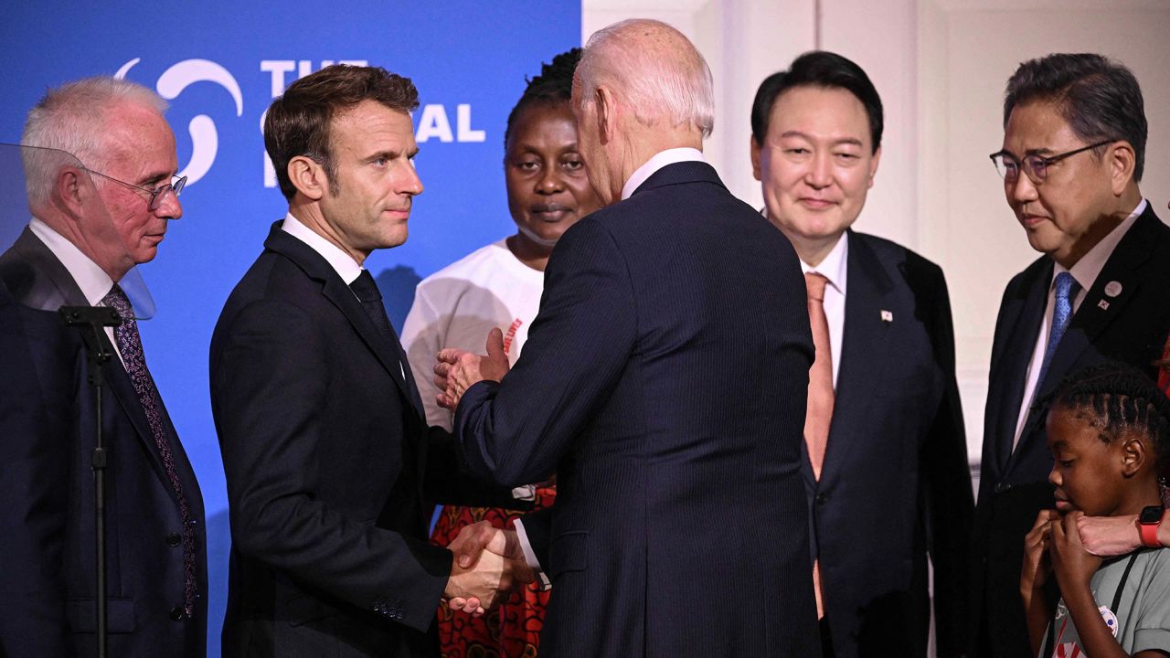 US President Joe Biden (back to camera) shakes hands with French President Emmanuel Macron during the Global Fund Seventh Replenishment Conference in New York on September 21, 2022. 