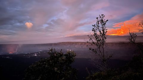 The Kilauea volcano lava lake, left, and a magnificent glow from Mauna Loa, upper right, sets the morning sky aglow.