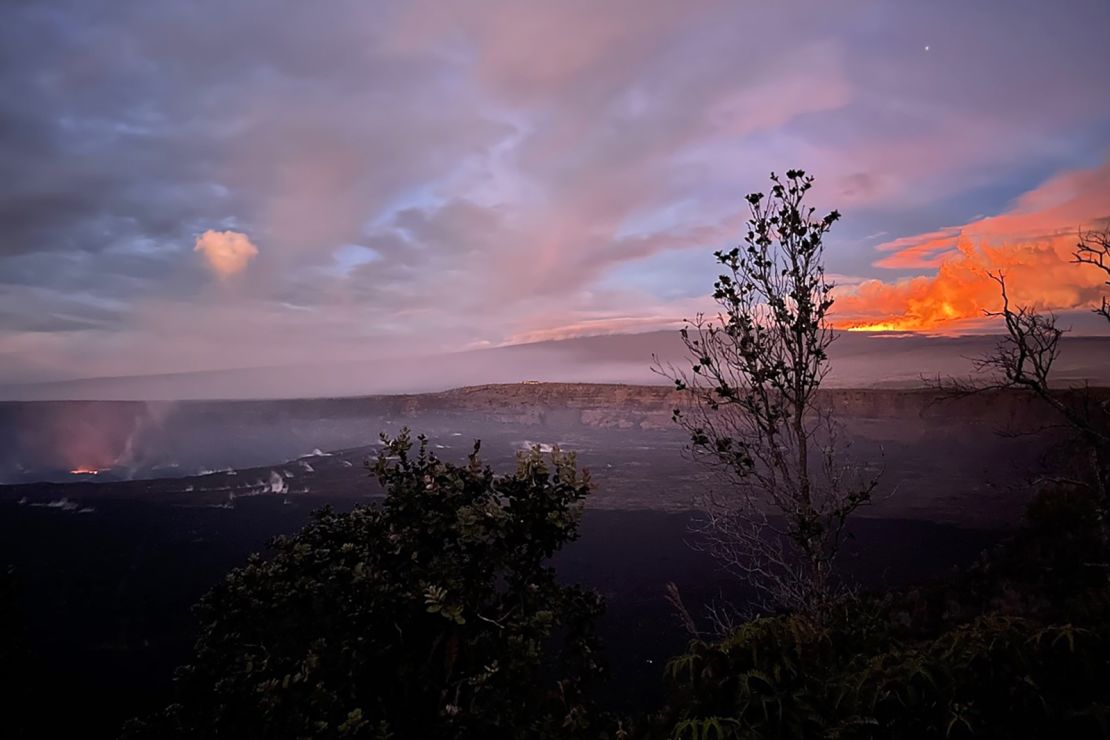 The Kilauea volcano lava lake, left, and a magnificent glow from Mauna Loa, upper right, sets the morning sky aglow.