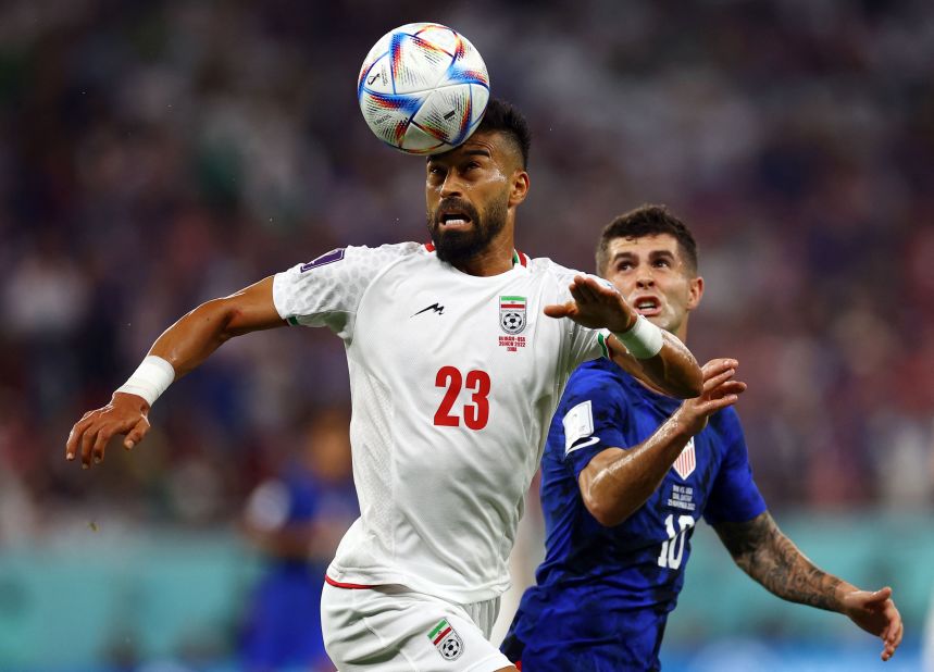 Iran's Ramin Rezaeian heads the ball during the match against the United States.