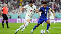 Iran's Sardar Azmoun (20) and United States' Tyler Adams battle for the ball during the World Cup group B soccer match between Iran and the United States at the Al Thumama Stadium in Doha, Qatar, Tuesday, Nov. 29, 2022. 