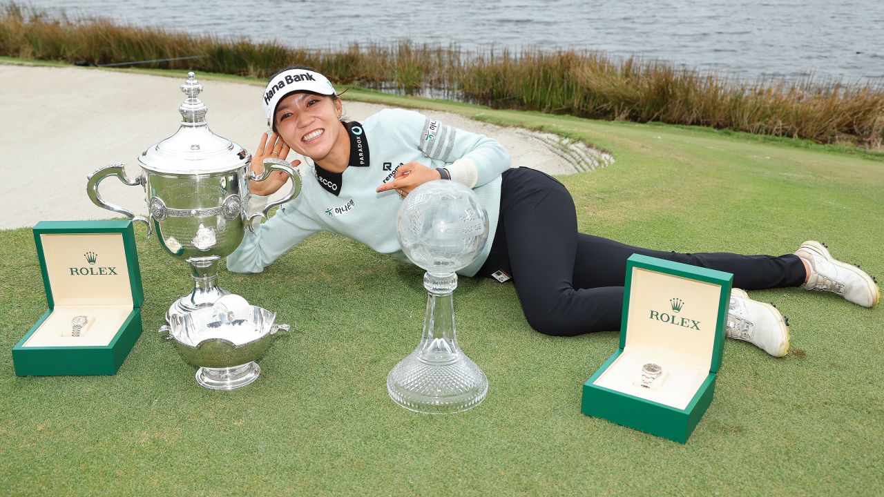 Lydia Ko poses with the Vare trophy, the Rolex Player of the Year trophy and the CME Globe trophy after winning the CME Group Tour Championship at Tiburon Golf Club on November 20 in Naples, Florida.